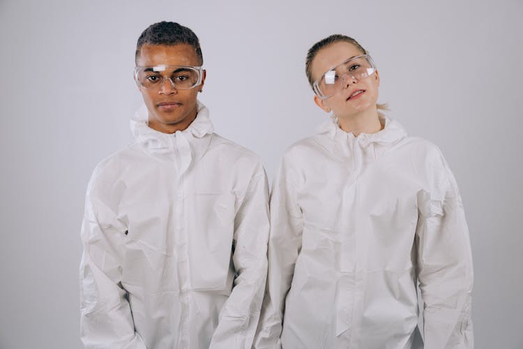 Scientists In PPE Standing Beside Each Other 