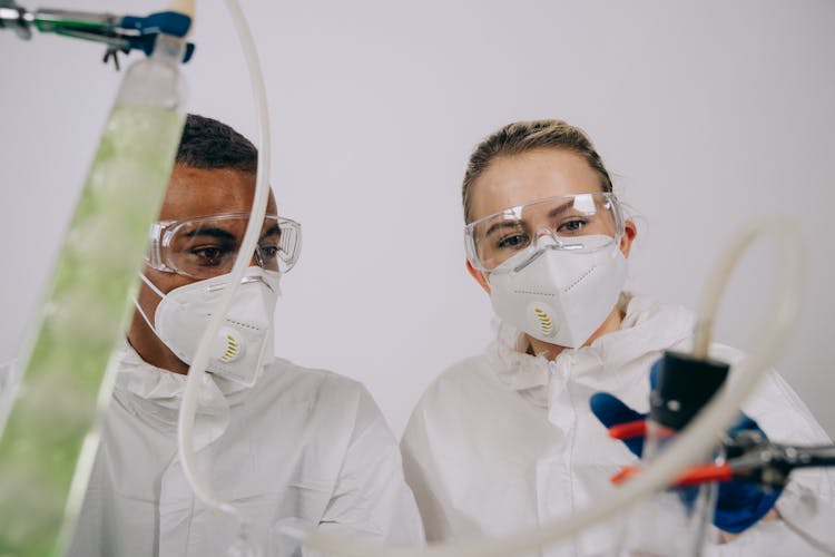 Man And Woman Looking At A Beaker