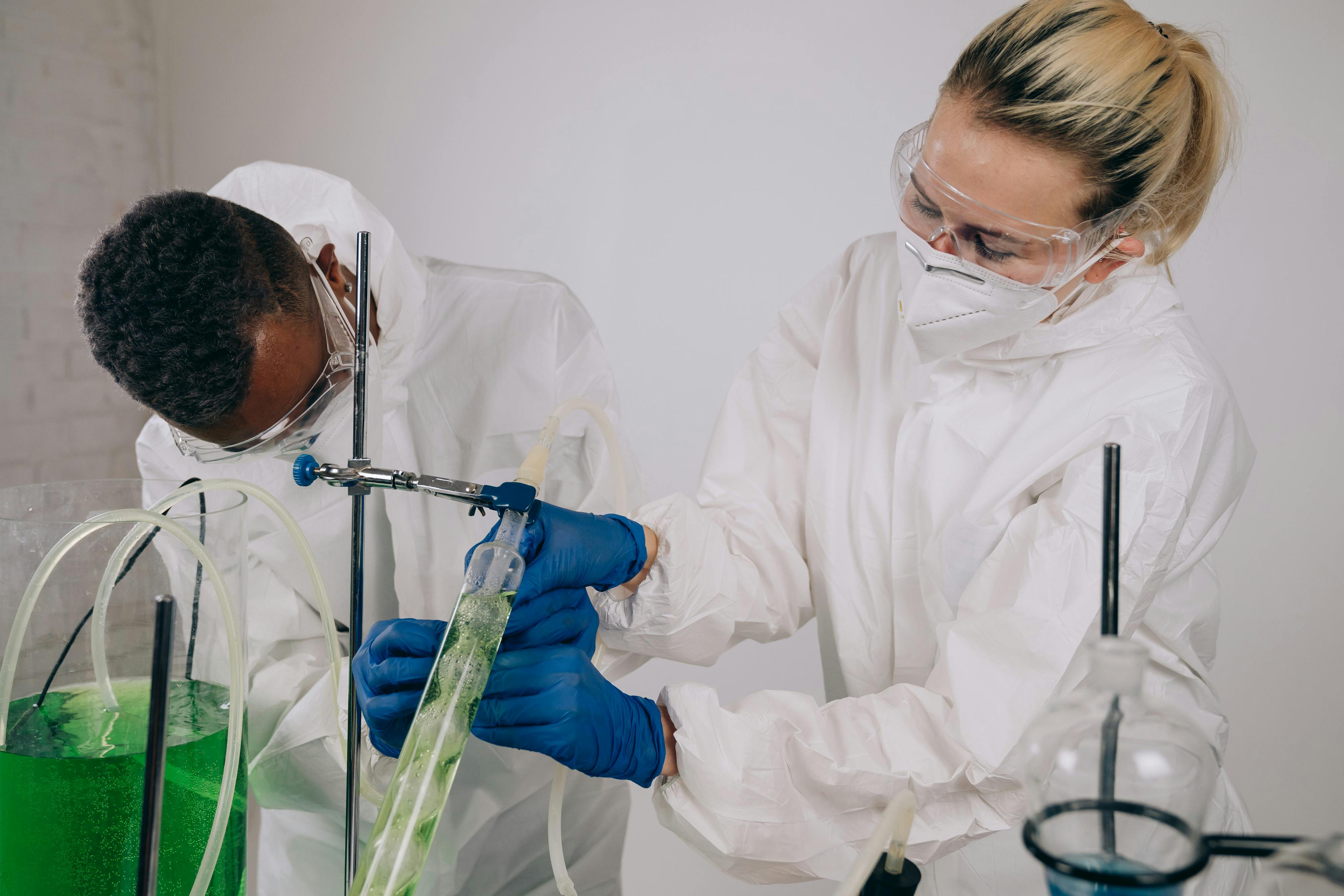 Laboratory technicians wearing protective gear in a cleanroom