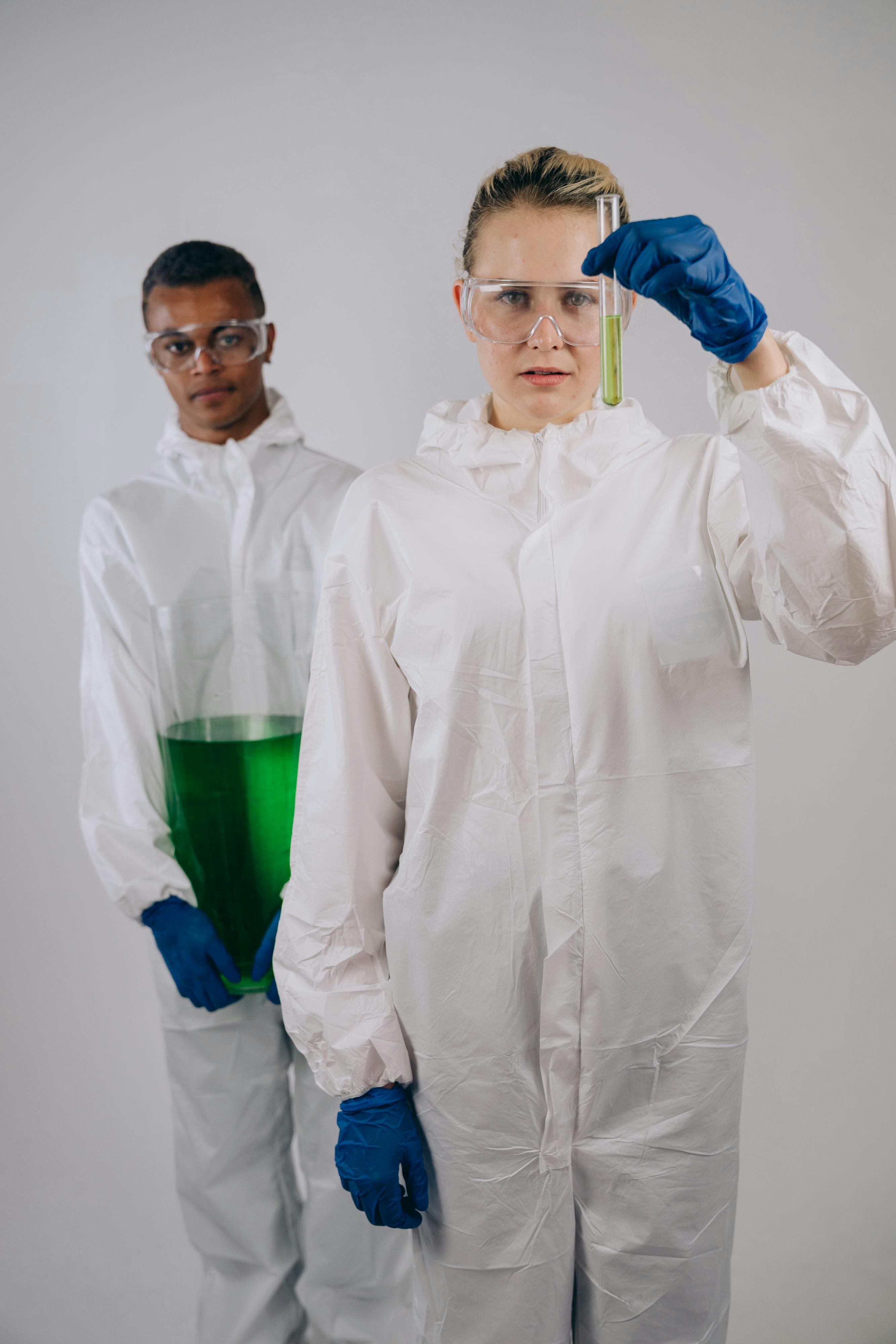 Chemists Holding Laboratory Apparatus with Chemical · Free Stock Photo