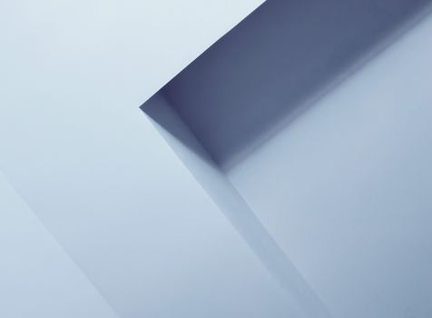 Close-up of abstract architectural elements creating geometric patterns in soft blue tones.