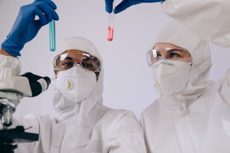 Researchers Holding Test Tubes 