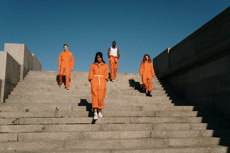 A Group Of Prisoners Standing On The Stairs