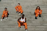 A Group of Prisoners Sitting on the Stairs