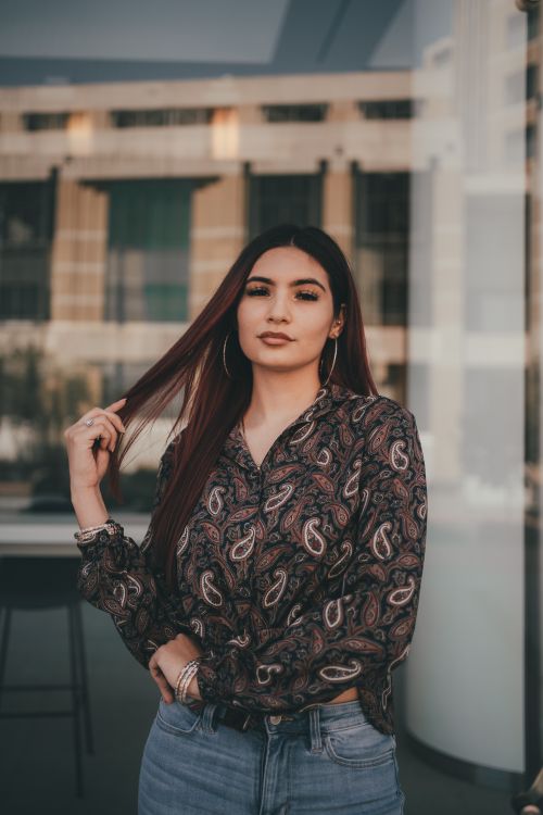 Free A fashionable woman posing confidently outdoors, showcasing her unique style. Stock Photo