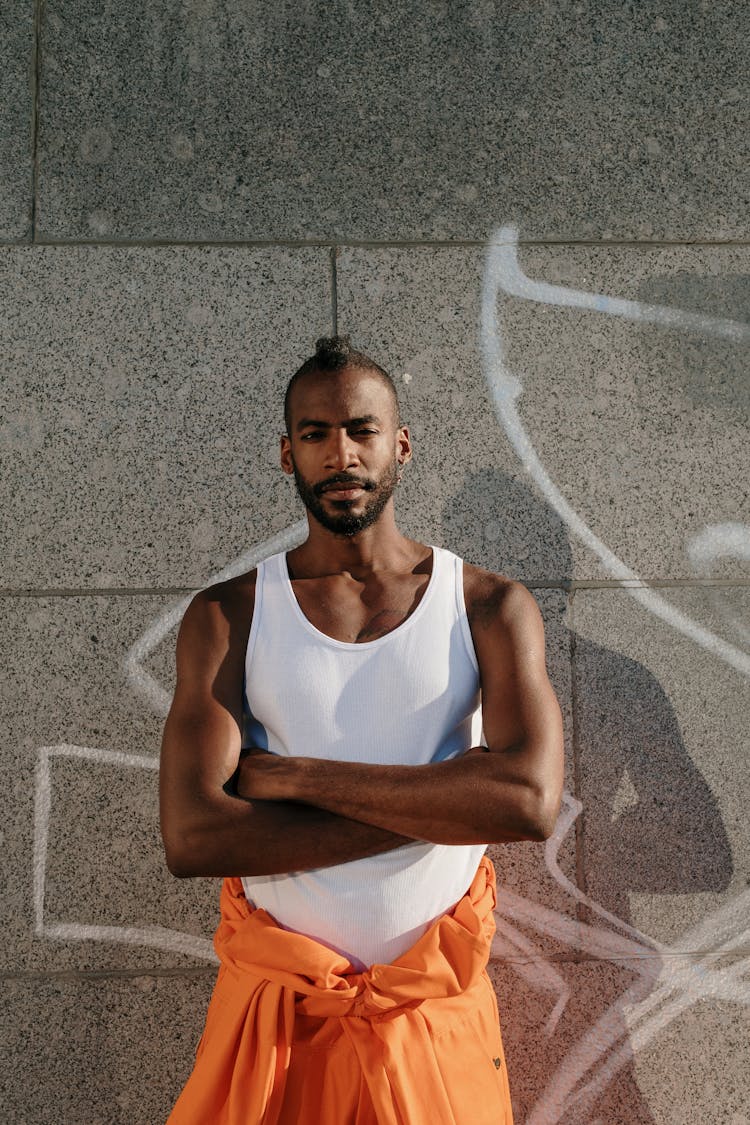 A Portrait Of A Man With His Arms Crossed