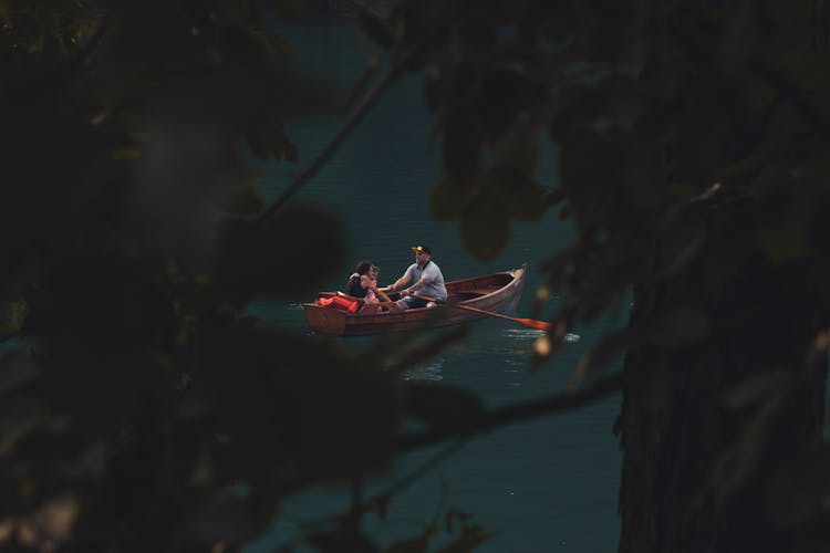 A Man Boating With His Wife And Daughter