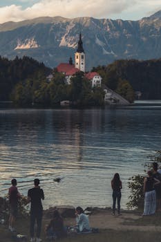 Captivating landscape of Lake Bled featuring a serene church and majestic mountains in Slovenia.