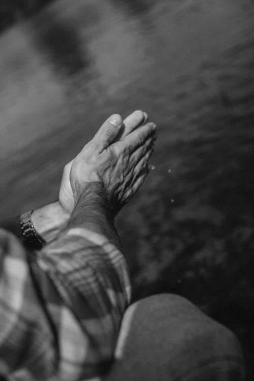 Grayscale Photo of a Person's Hands