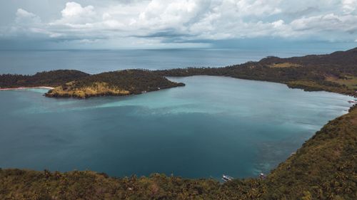 Free Stunning aerial view of a lush island and clear waters in Claveria, Bicol, Philippines. Stock Photo