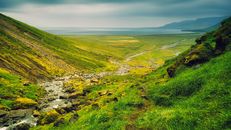 Green Grass Field and Mountain Under White Clouds