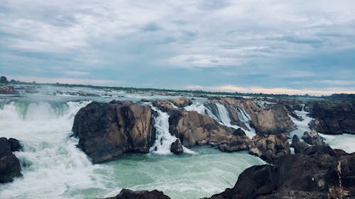 Landscape Photography of Rocks on Body of Water