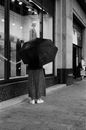 Woman in Black and White Floral Dress Holding Umbrella