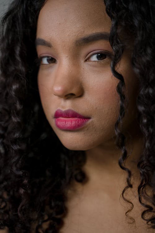 Close-Up Shot of a Pretty Curly-Haired Woman