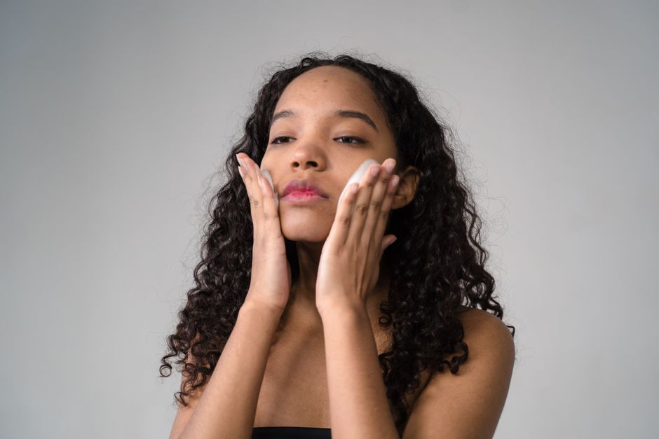 woman touching smooth clear face