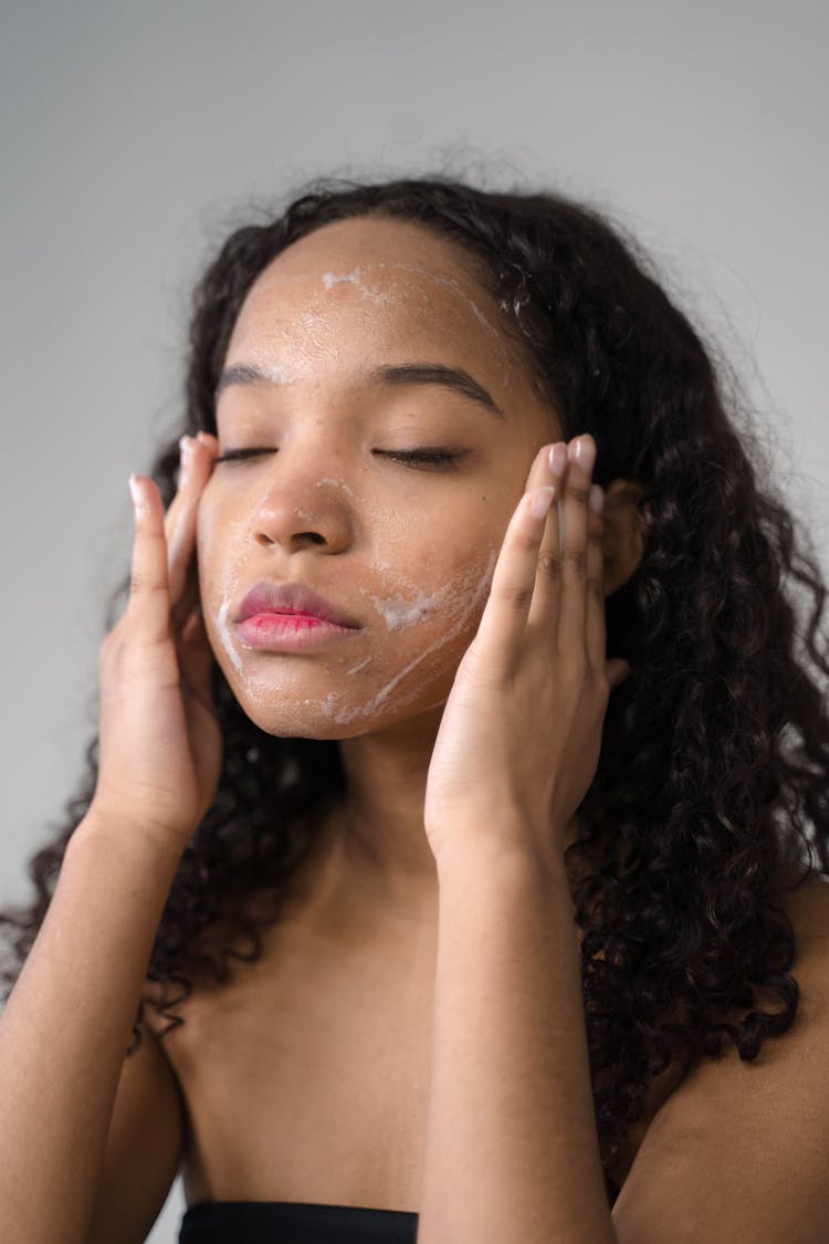A Girl Applying A Facial Wash