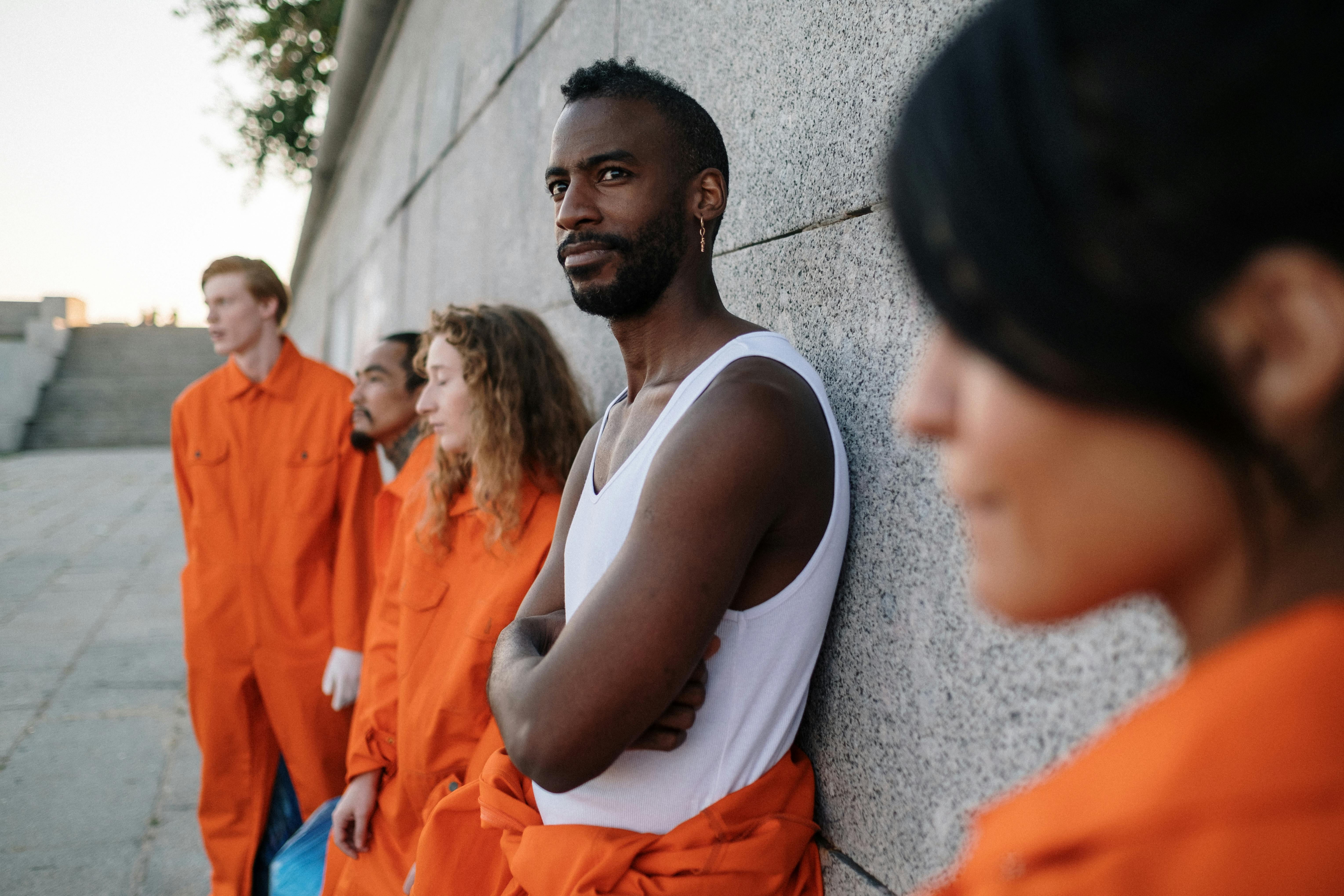 a group of prisoners leaning on the wall