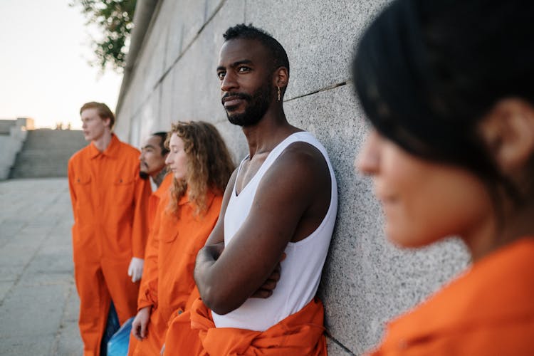 A Group Of Prisoners Leaning On The Wall