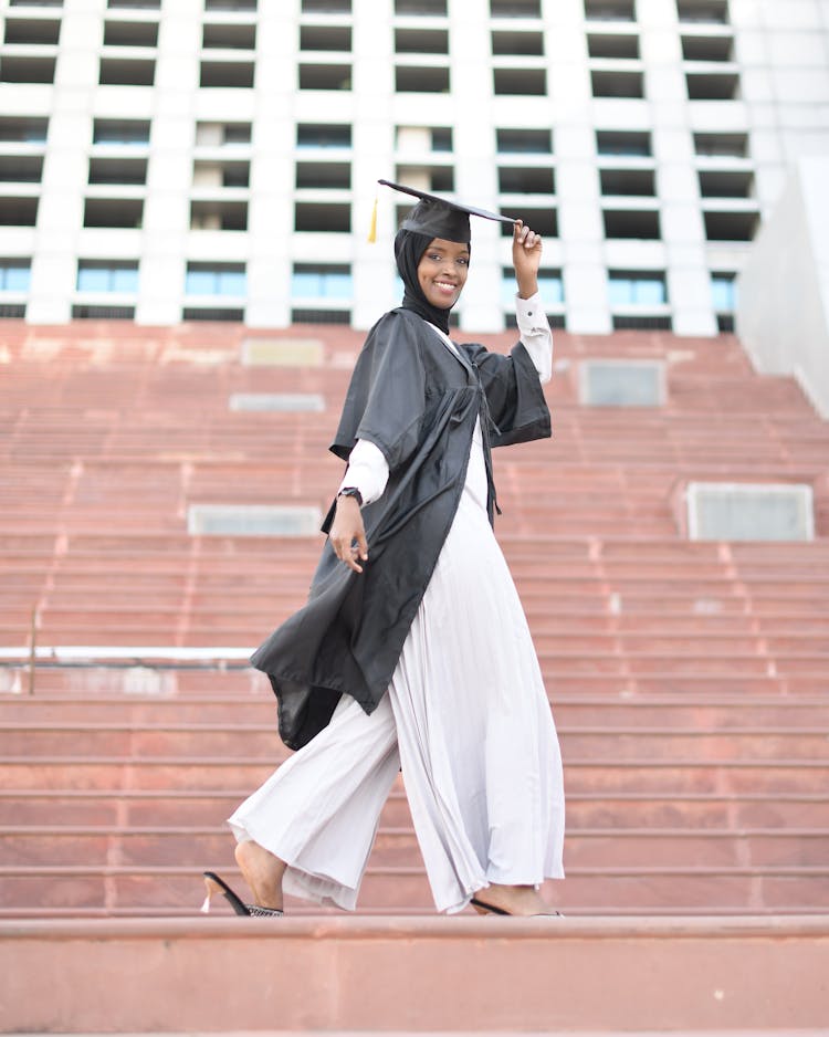 Model Posing In Mortarboard And Graduation Gown