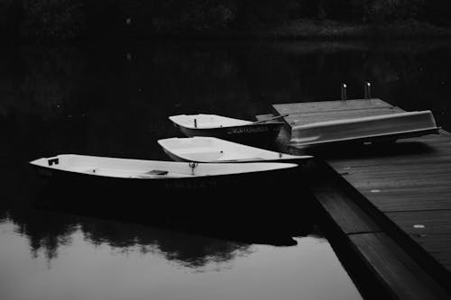 Grayscale Photography of  of Boats Beside the Wooden Dock