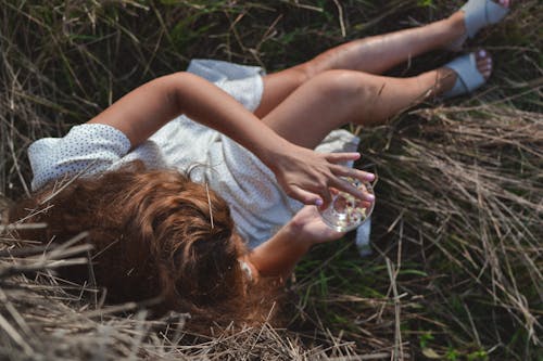 Woman Lying on a Field in Summer 