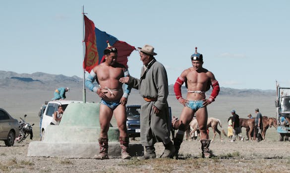 Traditional Mongolian wrestlers participating in an outdoor festival event.