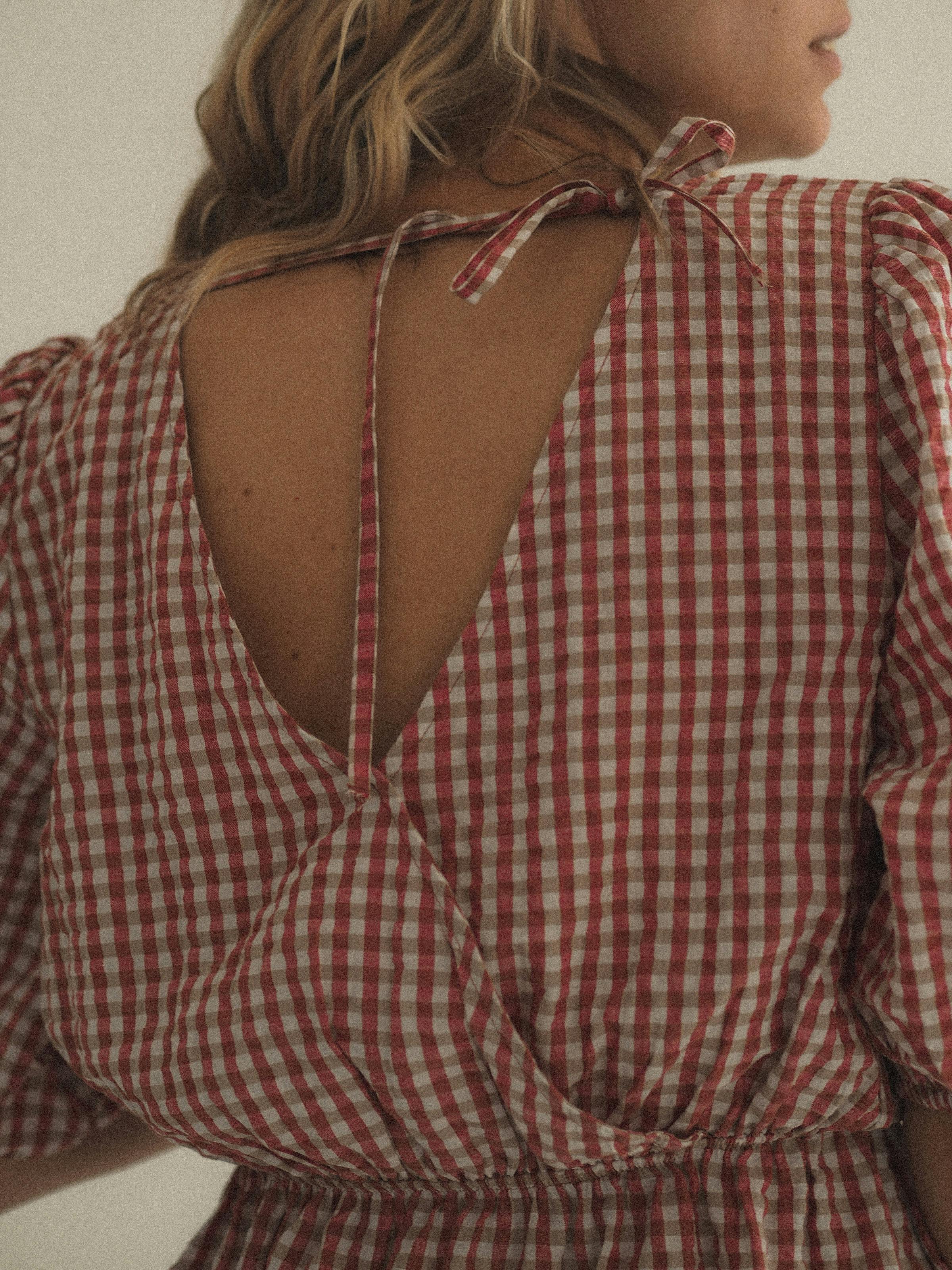 woman in red and white plaid dress