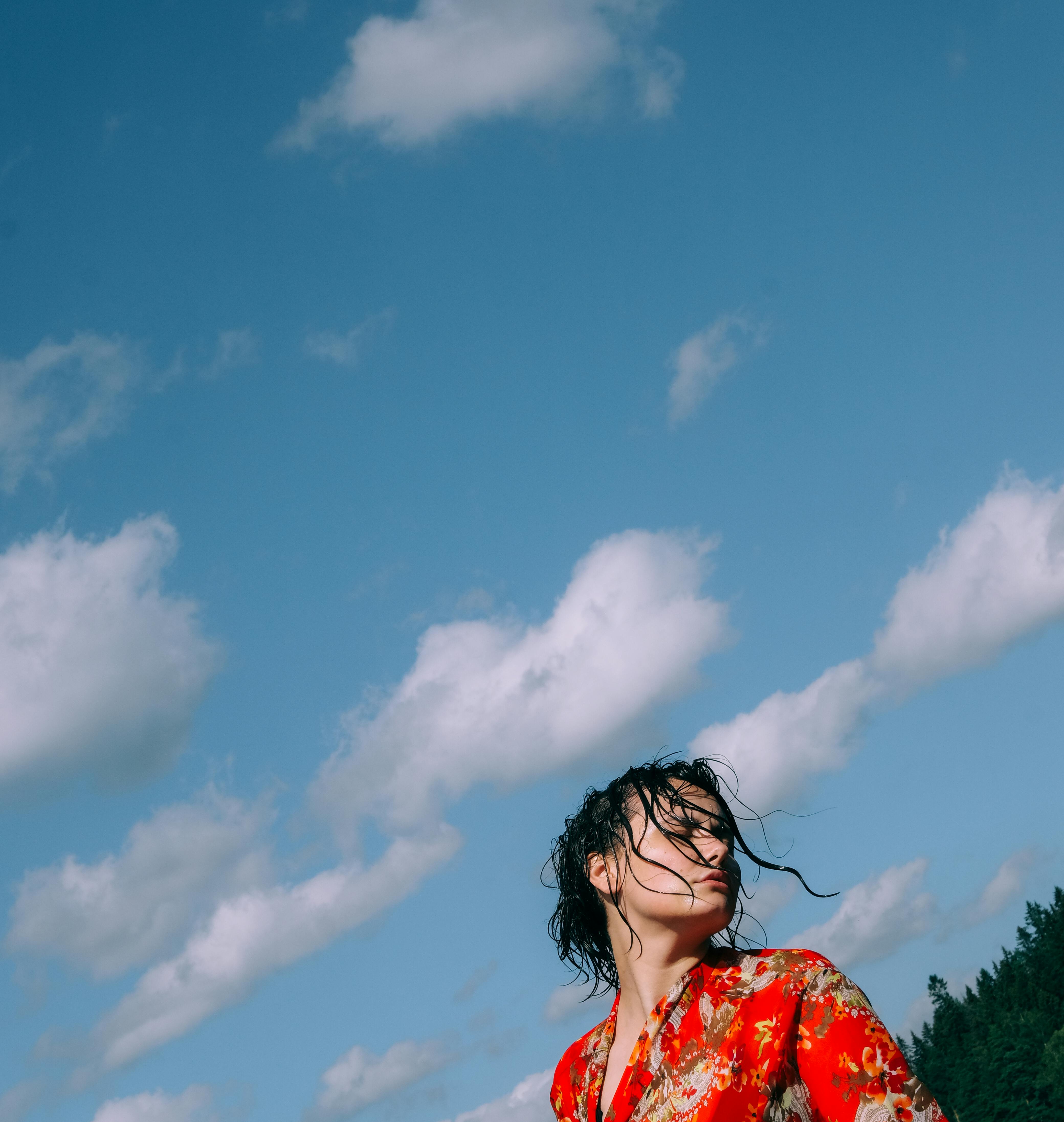Close-up of a person using a TV remote in a cozy living room.