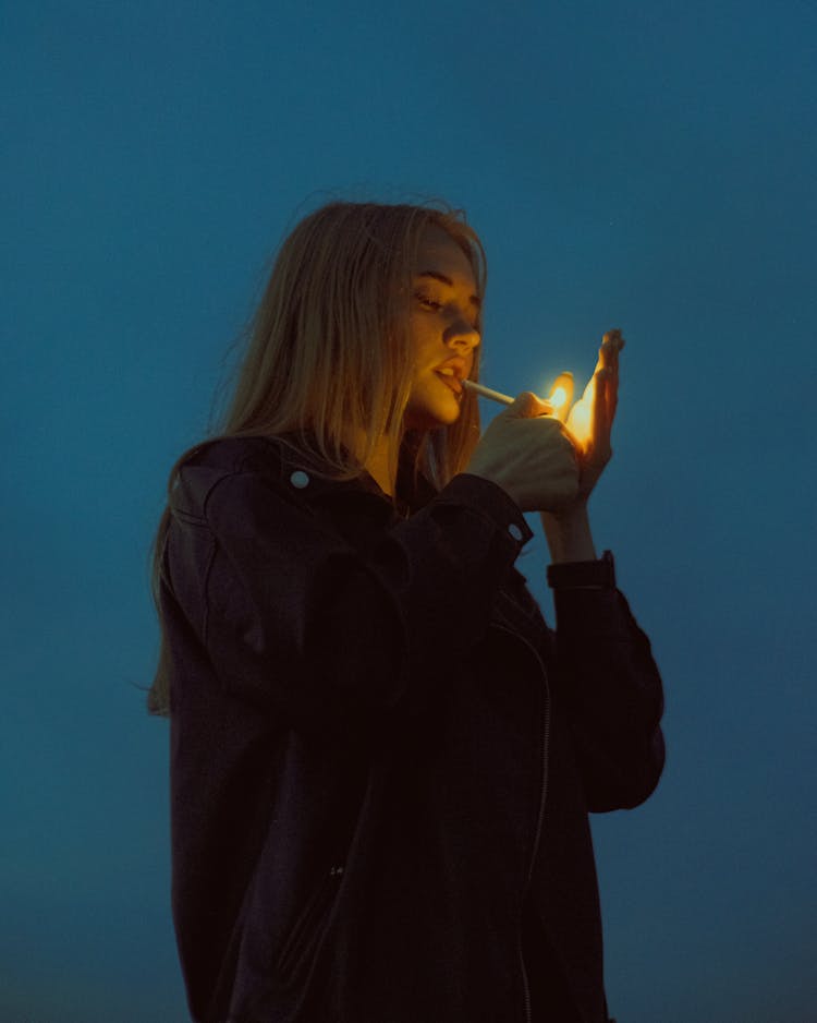 A Woman Lighting A Cigarette 