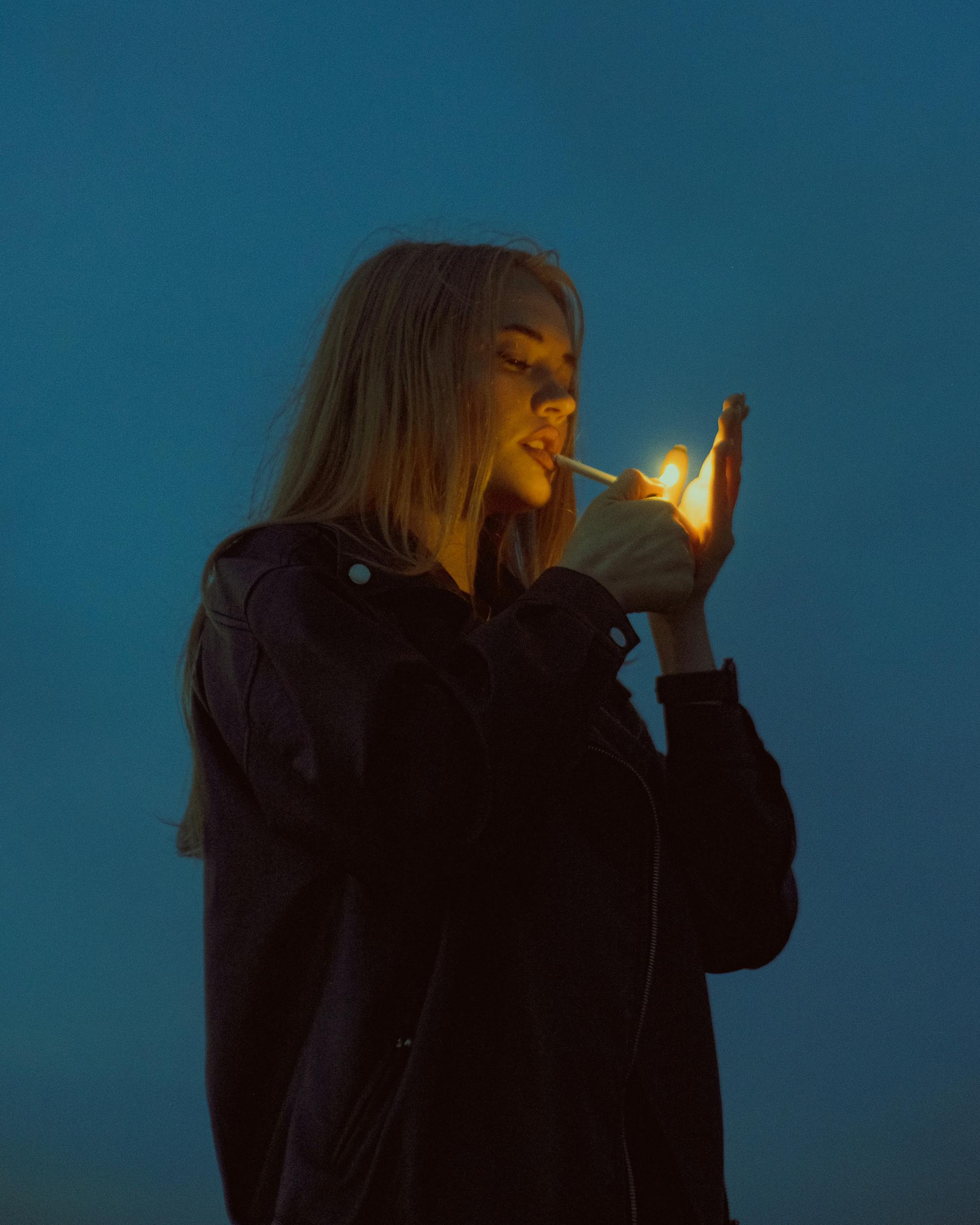 girl lighting cigarette