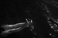 Grayscale Photo of Legs in the Water