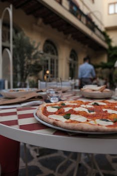 A delicious pizza on a checkered table at an outdoor restaurant setting