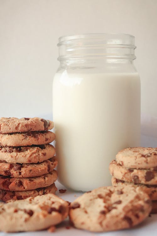 Free Close-Up Shot of Chocolate Chip Cookies and Milk Stock Photo