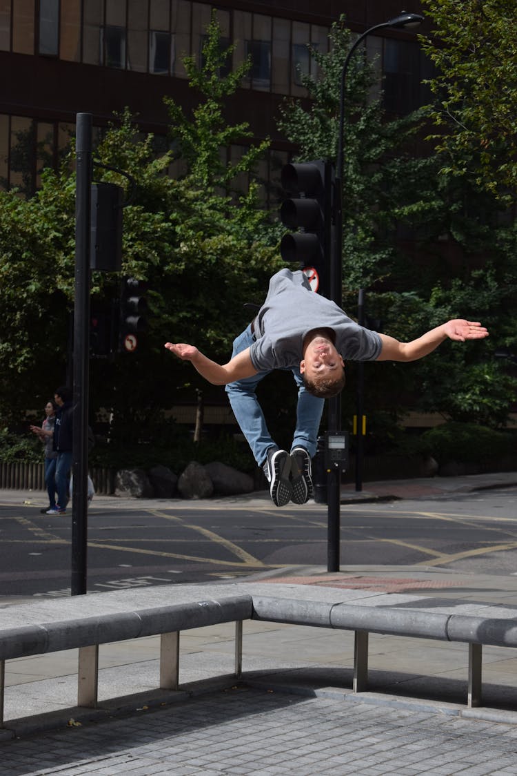 Man In Gray Shirt And Blue Denim Jeans Tumbling Backwards