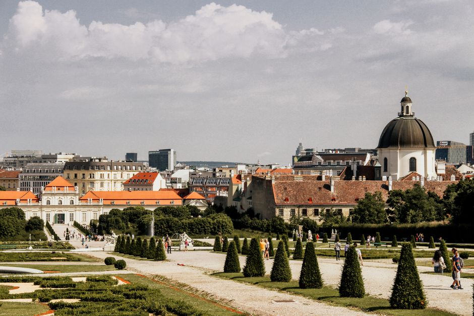 Scenic view of Vienna's historic architecture featuring a prominent dome and lush gardens.