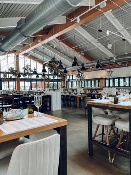 Bright and airy restaurant interior featuring modern design and natural lighting with neatly arranged tables.
