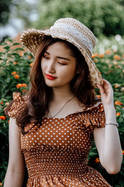 Woman in a Polka Dot Top and a Sun Hat