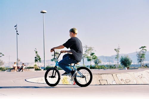 Free Man in Black T-shirt Riding a Bicycle Stock Photo