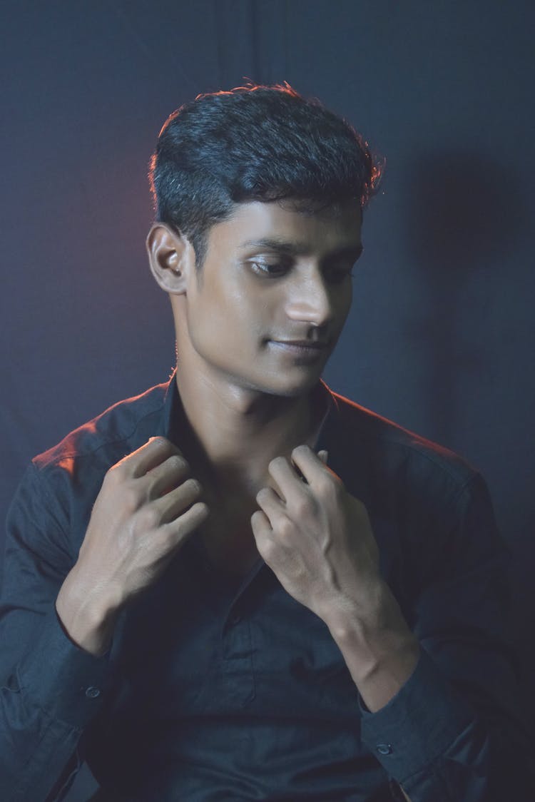 Close-Up Photo Of A Handsome Man Touching The Collar Of His Shirt