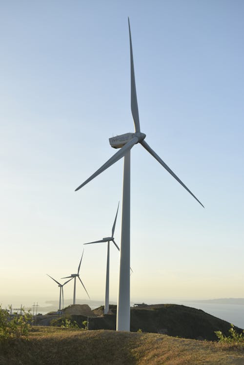 Free Photo of White Wind Turbines Under a Clear Sky Stock Photo