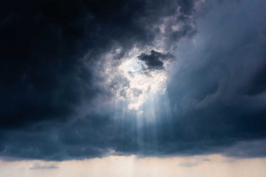 Sun Shining Through Dramatic Dark Clouds 