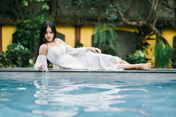 Pensive Asian Woman Near Swimming Pool