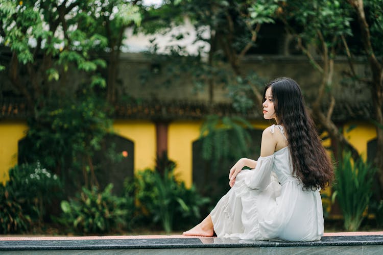 Pensive Asian Woman On Edge Of Pool