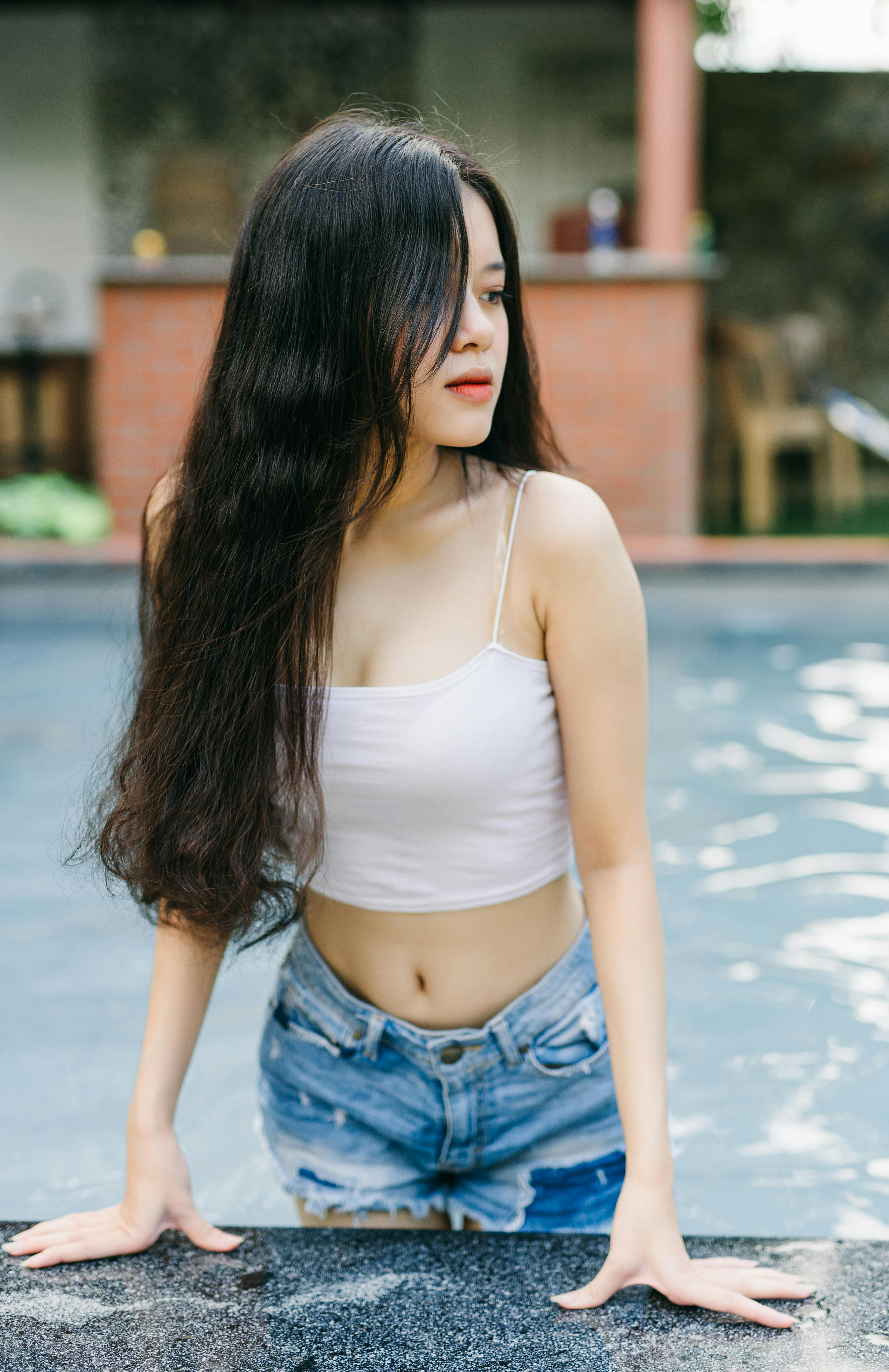 Charming Asian woman in pool on terrace · Free Stock Photo