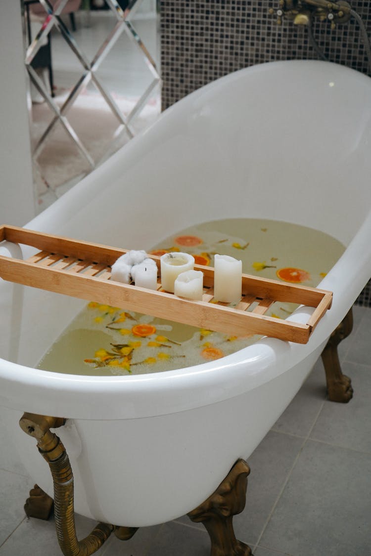 Freestanding Bathtub With Water And Fruit Slices