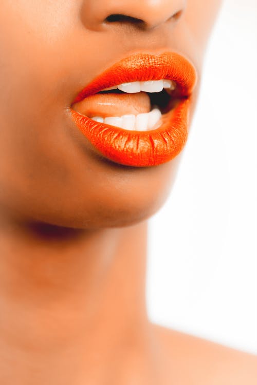 Selective Focus Photography of Woman With Orange Lipstick