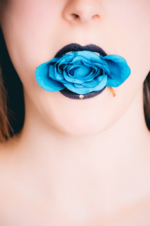 Woman Wearing Black Lipstick With Blue Rose on Mouth