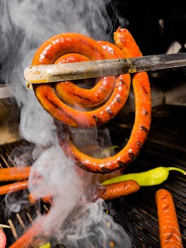 Close-up of a mouth-watering sausage being grilled with smoky aroma.
