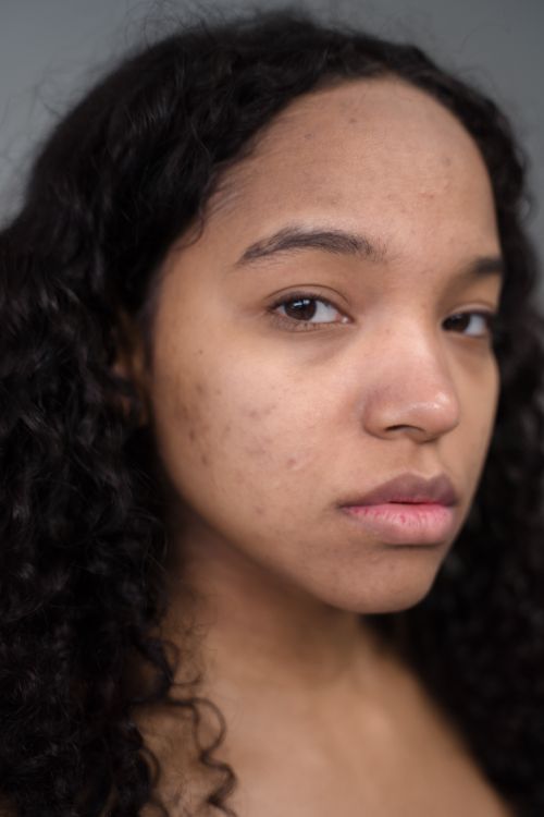 Free Close-up portrait highlighting natural features and skin texture of a young woman. Stock Photo