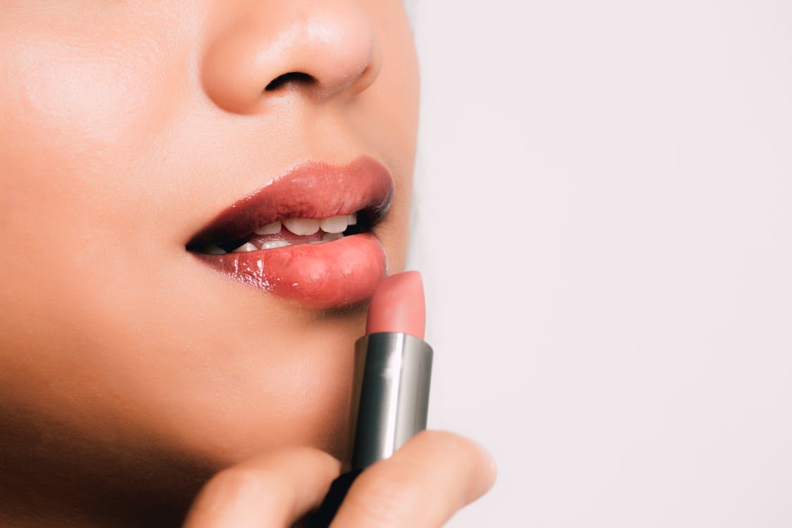 Woman Holding a Pink Lipstick